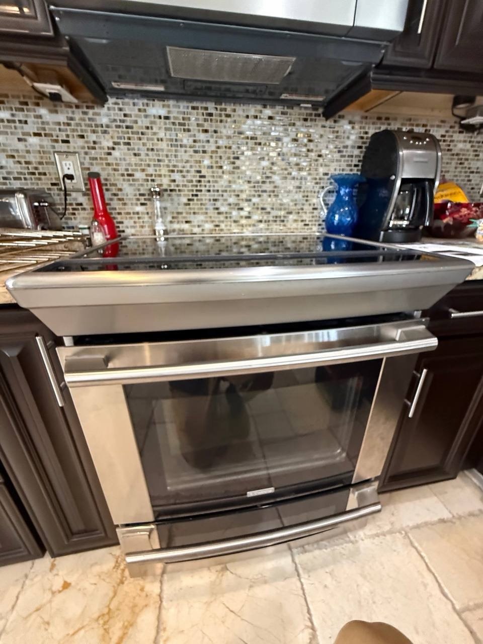 Oven repair in progress in a Naples home