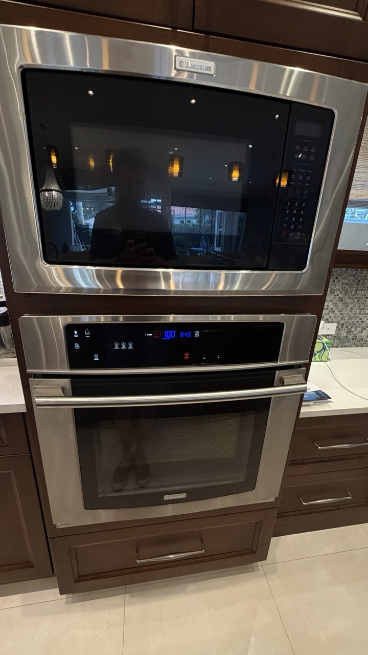 Oven repair in progress in a Naples home